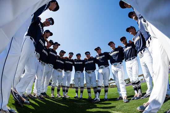mens tritons baseball team standing with arms each other in a circle