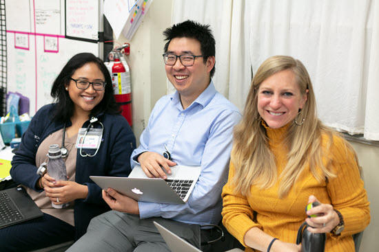 student physician volunteer examines patient with stethoscope